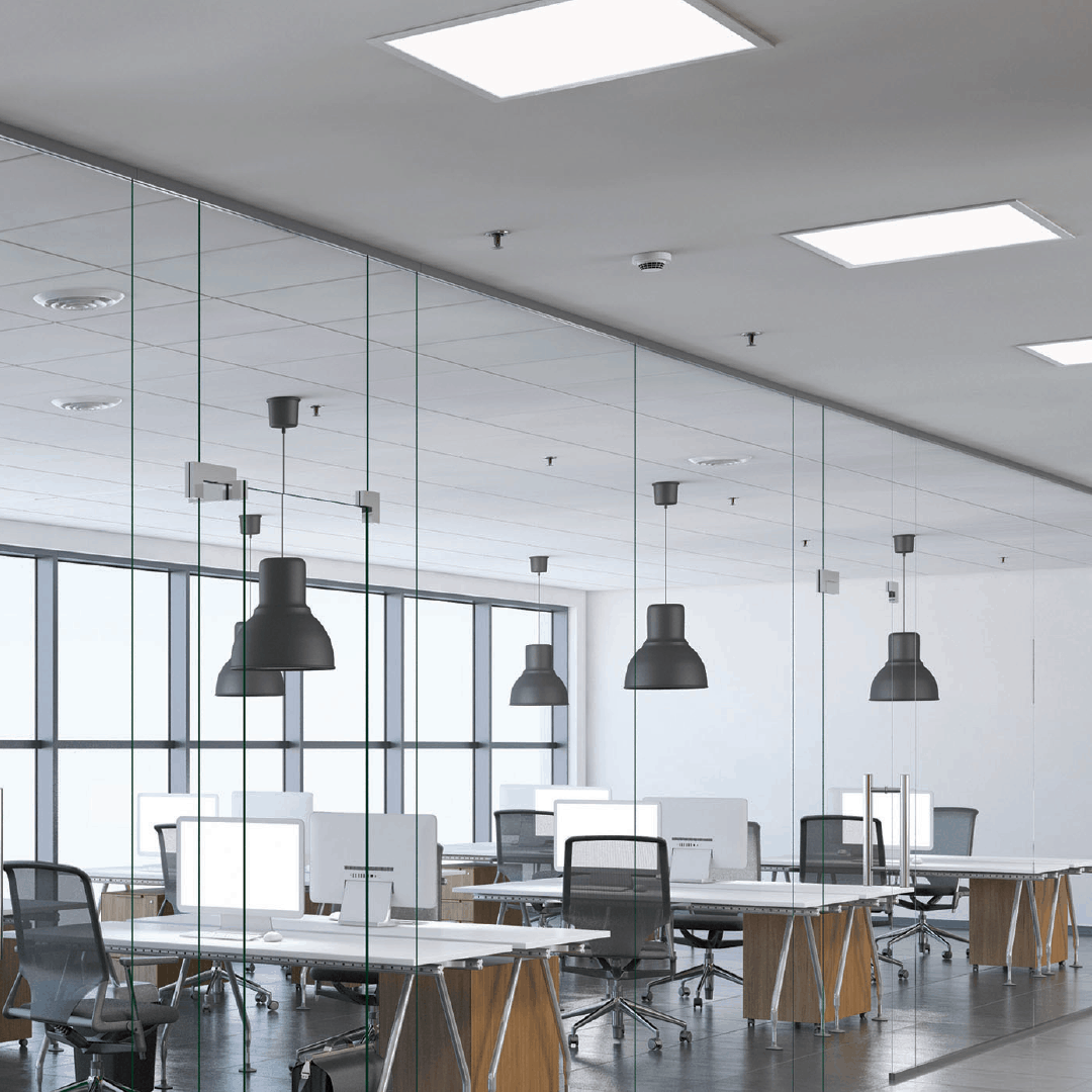 Large industrial lighting hanging above desks