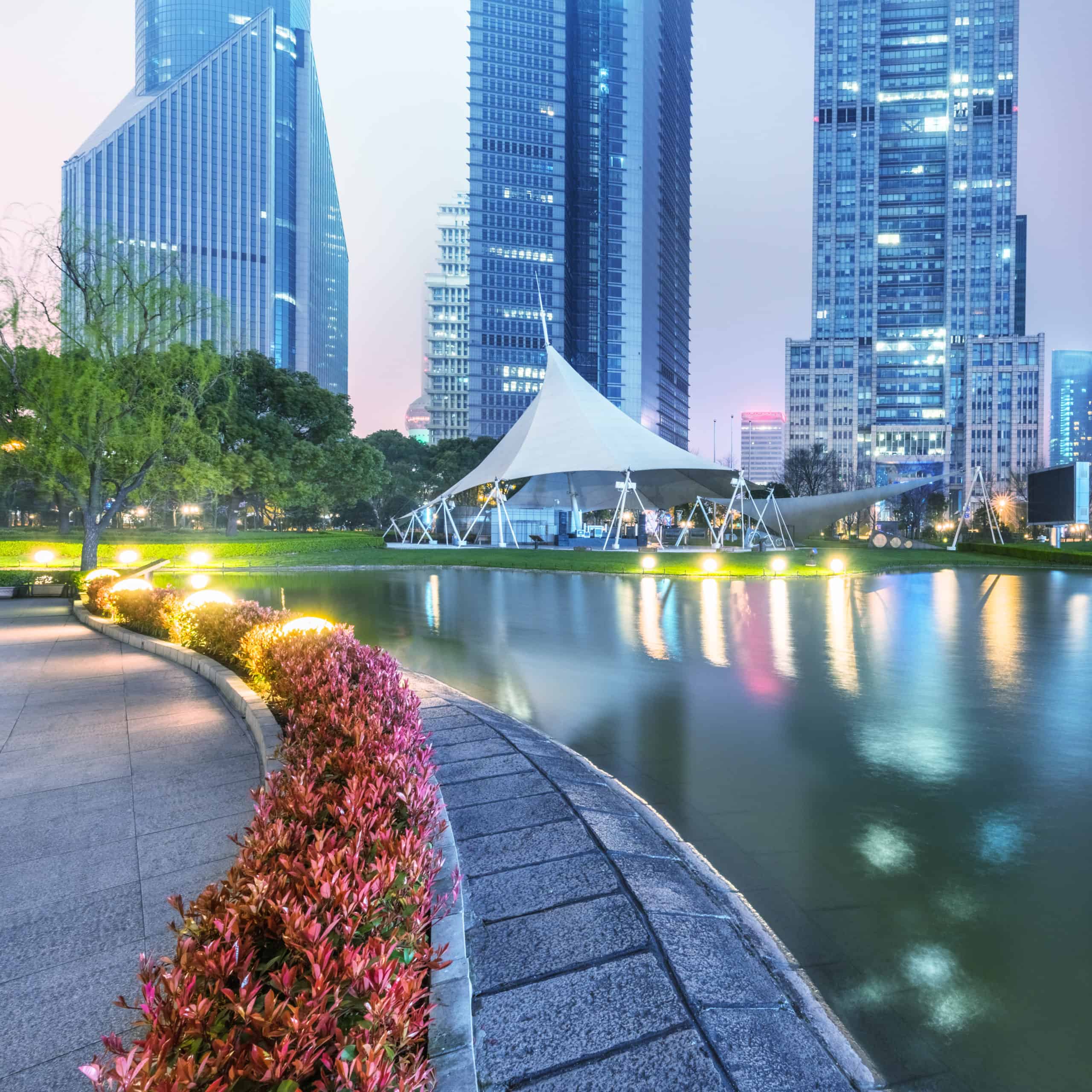 Outdoor tent on lawn with city in background